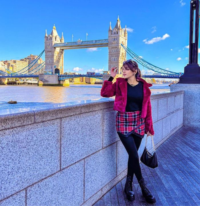 Magenta Faux Fur Coat And Black Top With Plaid Skirt