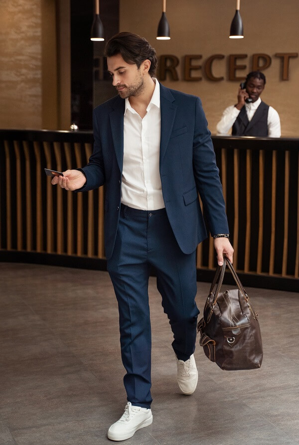 full shot man wearing button-down shirt and blue pant