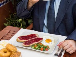 man drinking tea with fresh food