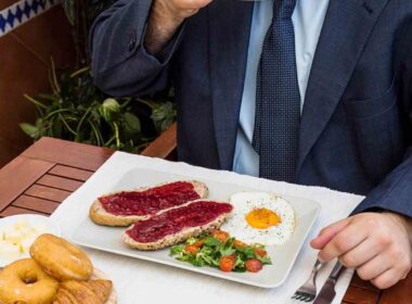 man drinking tea with fresh food