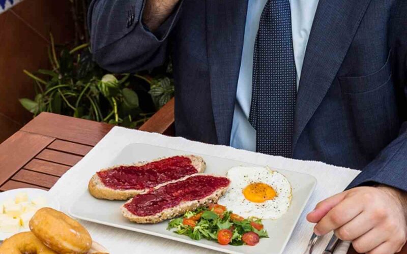 man drinking tea with fresh food